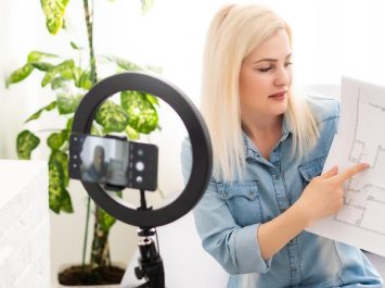 calm-clever-woman-standing-bedroom-front-camera-tripod-vizrq